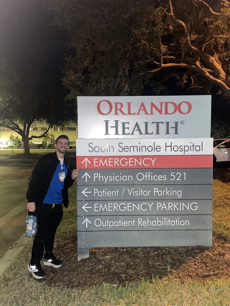 T.J. Walker standing beside an Orlando Health emergency department sign